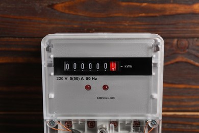 Electric meter on wooden wall. Energy measuring device