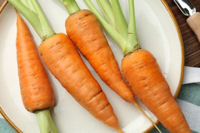 Photo of Tasty ripe juicy carrots on table, top view