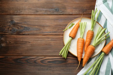 Tasty ripe juicy carrots on wooden table, top view. Space for text