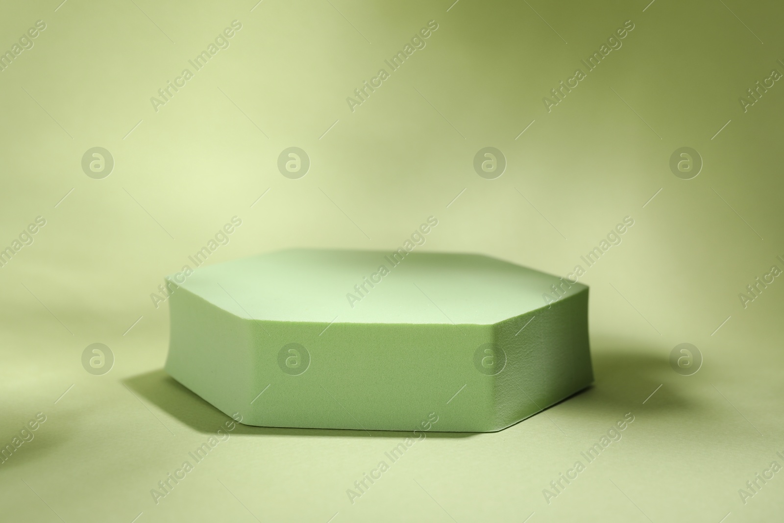 Photo of Presentation of product. Podium and shadows on light green background. Space for text