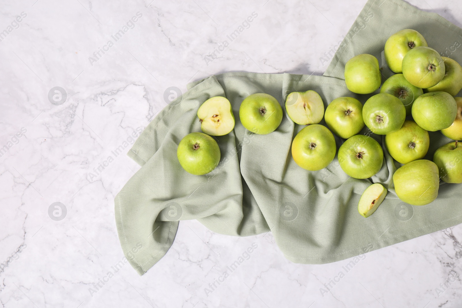 Photo of Fresh ripe green apples on white marble table, flat lay. Space for text