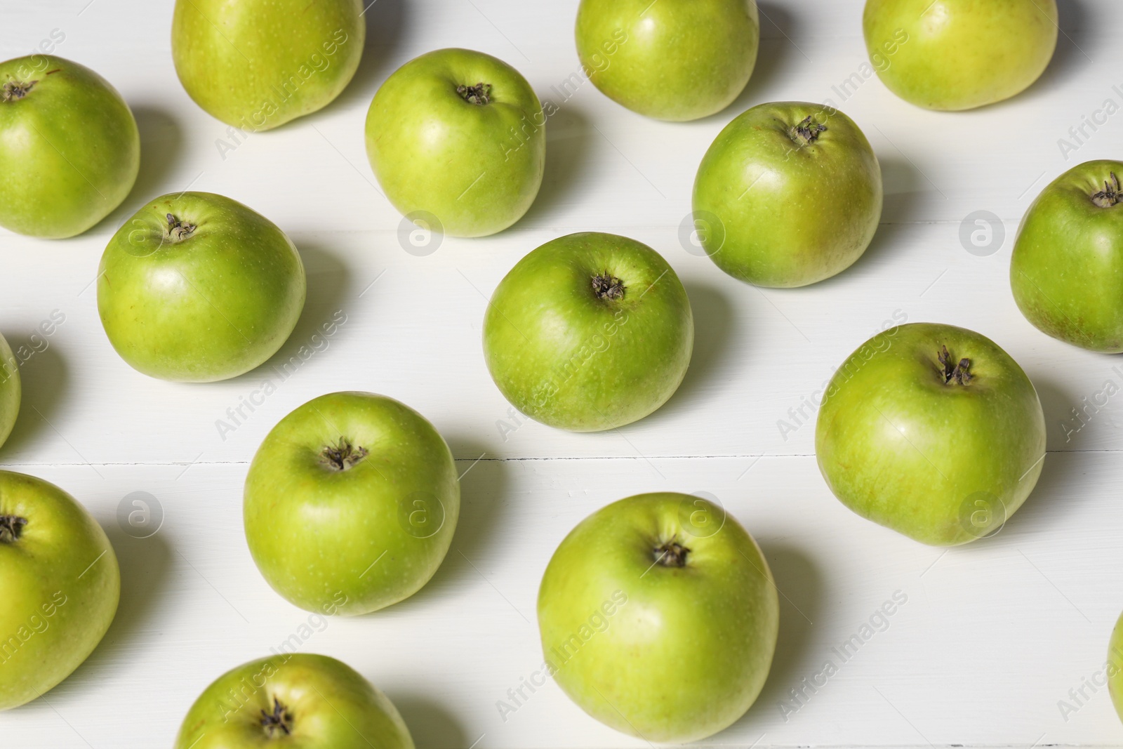 Photo of Fresh ripe green apples on white wooden table