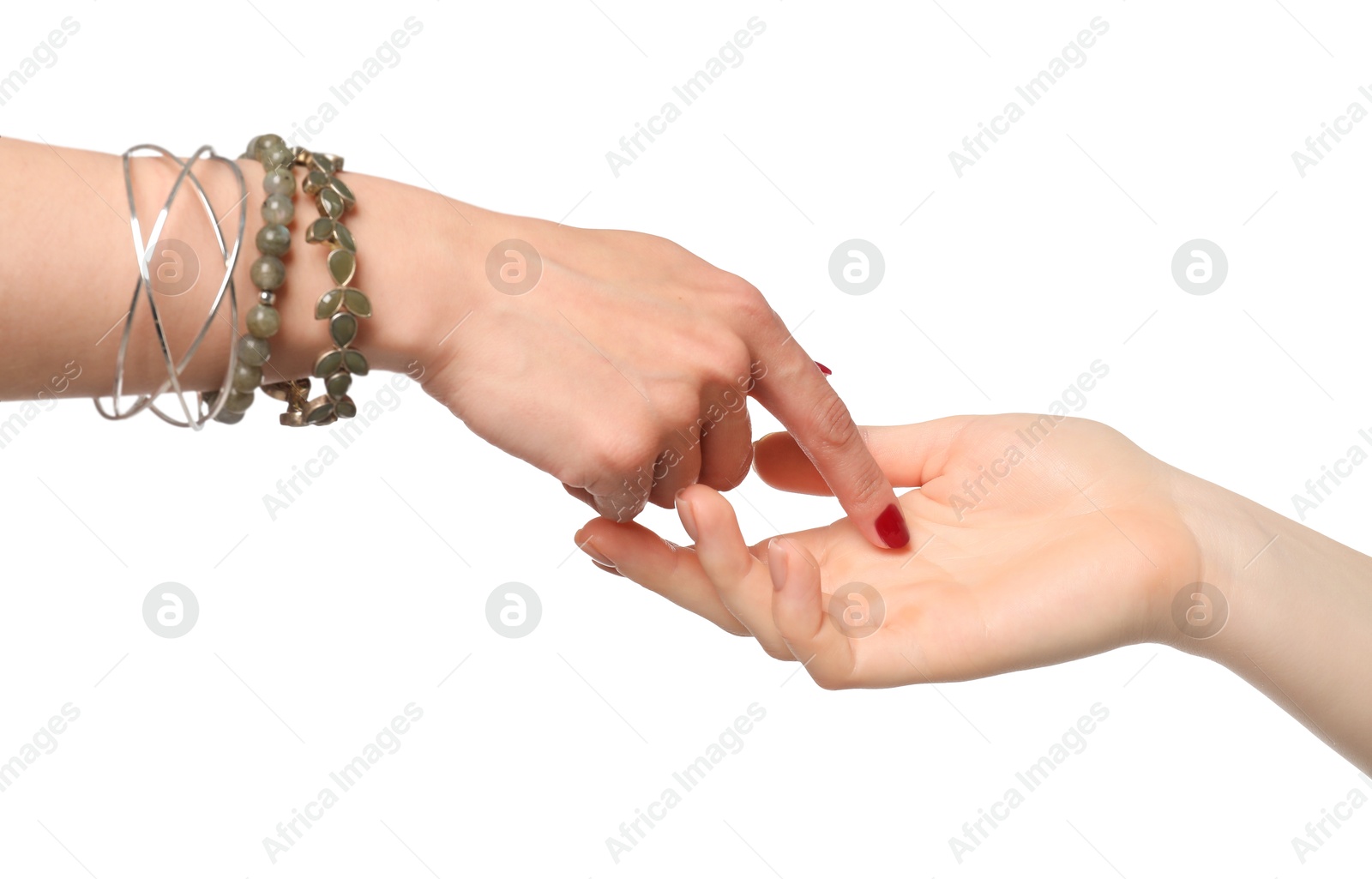 Photo of Fortune teller reading lines on woman's palm against white background. Chiromancy
