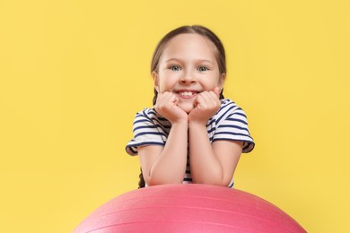 Photo of Cute little girl with fit ball on white background