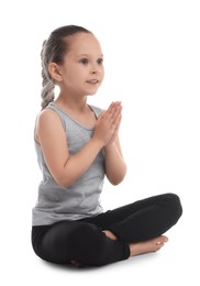 Photo of Cute little girl practicing yoga on white background