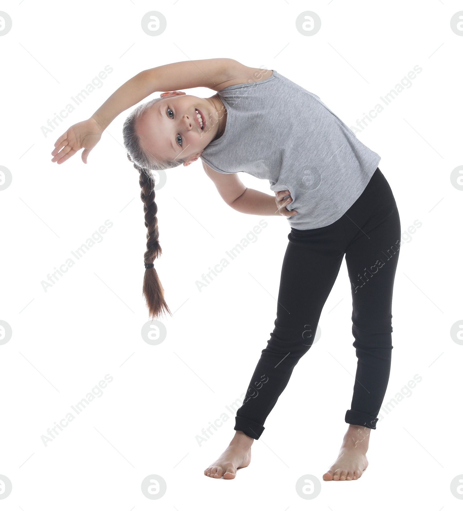 Photo of Cute little girl stretching on white background