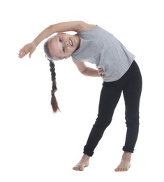 Photo of Cute little girl stretching on white background