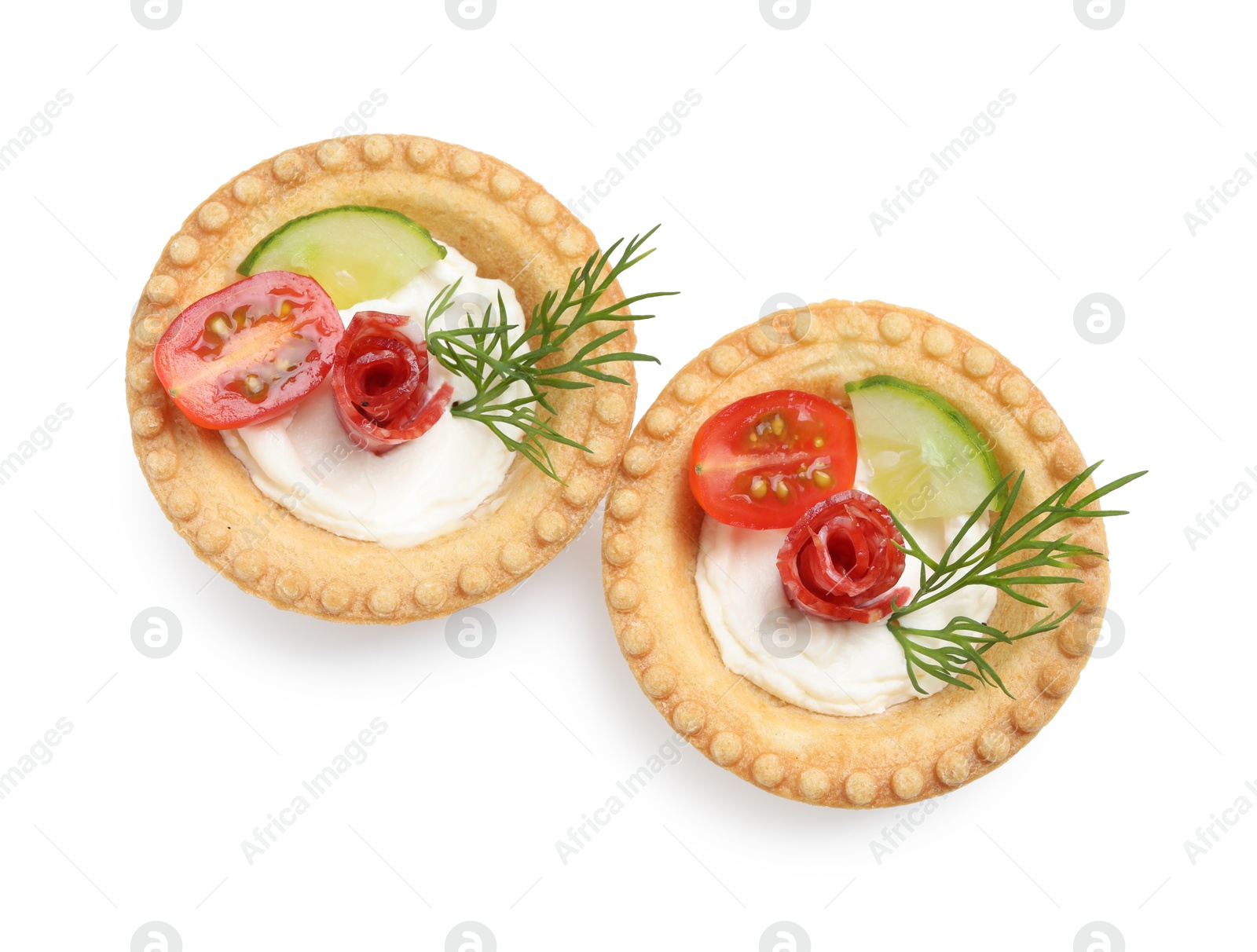 Photo of Delicious canapes with dry smoked sausages, cream cheese and vegetables isolated on white, top view