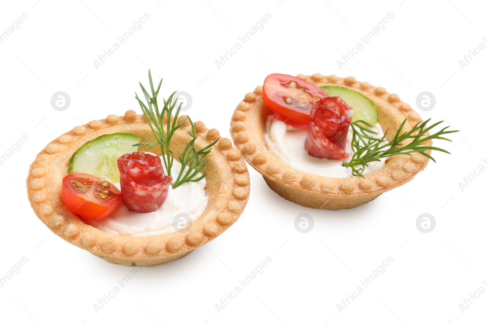 Photo of Delicious canapes with dry smoked sausages, cream cheese and vegetables isolated on white