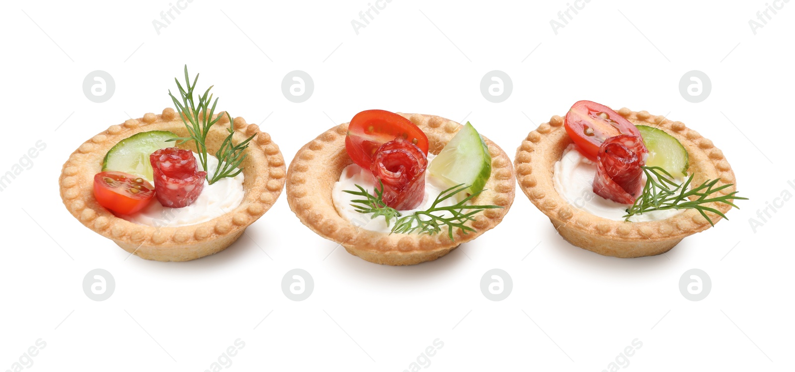 Photo of Delicious canapes with dry smoked sausages, cream cheese and vegetables isolated on white