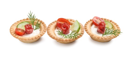 Photo of Delicious canapes with dry smoked sausages, cream cheese and vegetables isolated on white