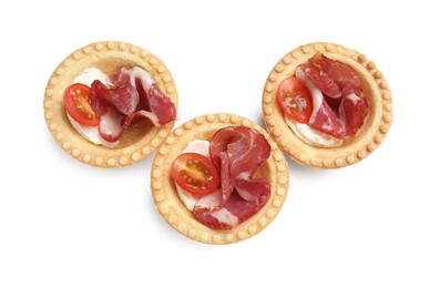 Delicious canapes with jamon, cream cheese and cherry tomatoes isolated on white, top view