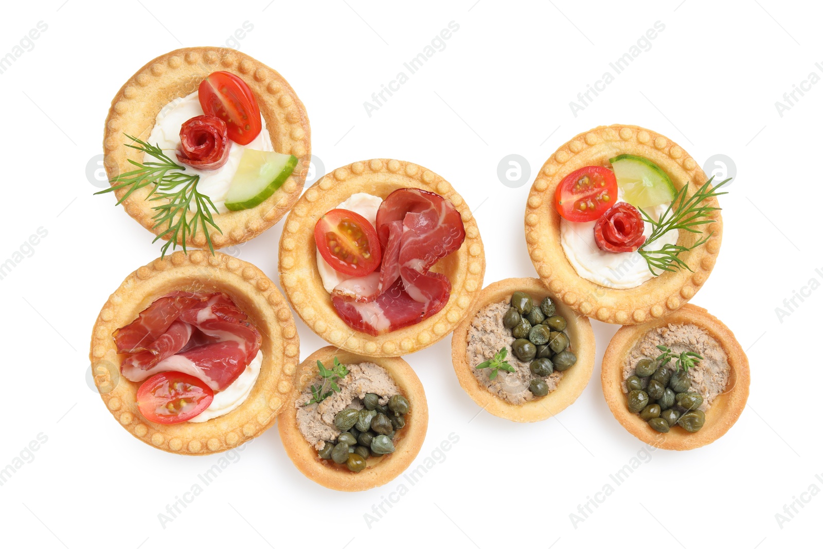 Photo of Delicious canapes with dry smoked sausages, jamon and pate isolated on white, top view