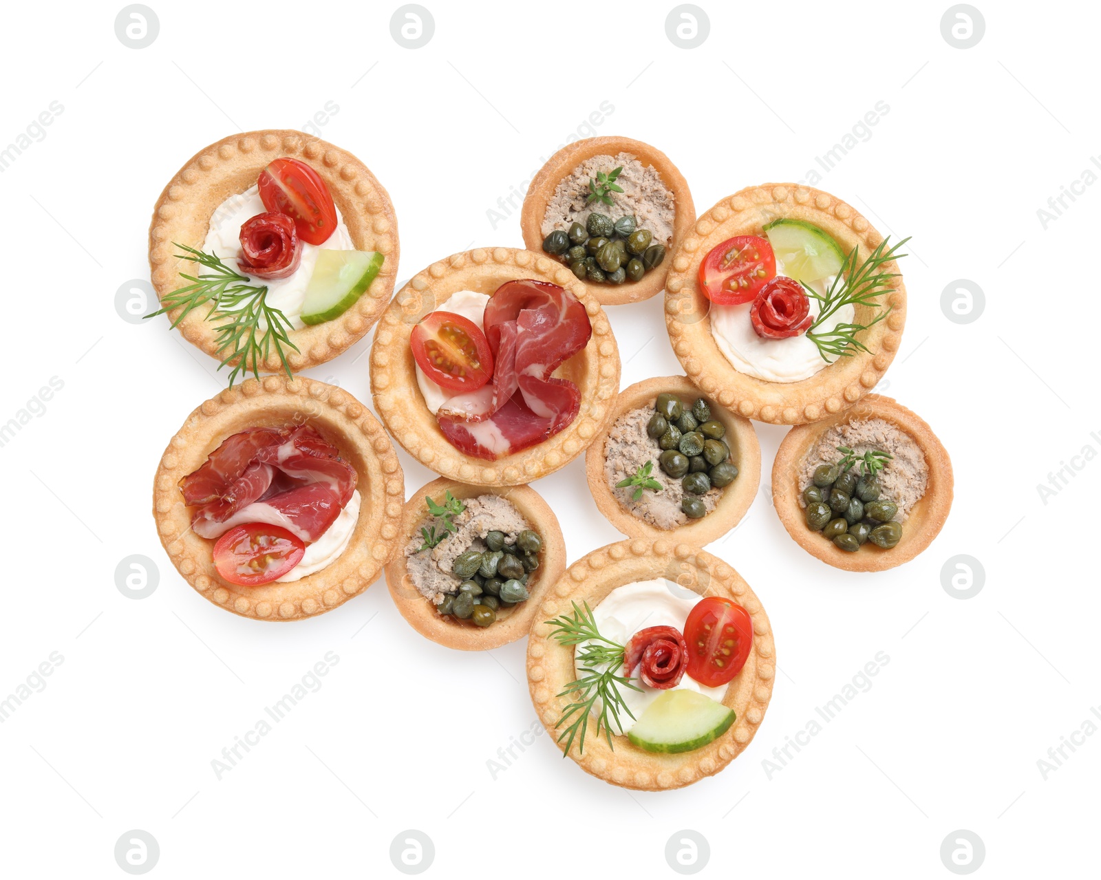 Photo of Delicious canapes with dry smoked sausages, jamon and pate isolated on white, top view