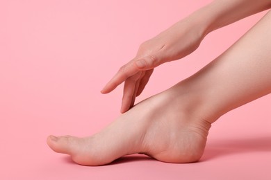 Closeup view of woman`s groomed foot after care procedure on pink background