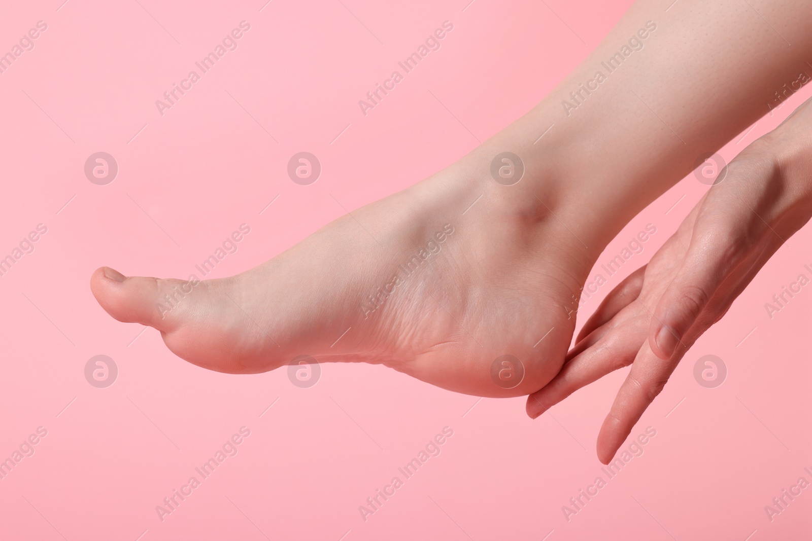 Photo of Closeup view of woman`s groomed foot after care procedure on pink background