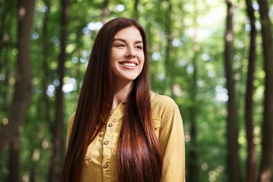 Portrait of smiling woman in forest. Spring vibes