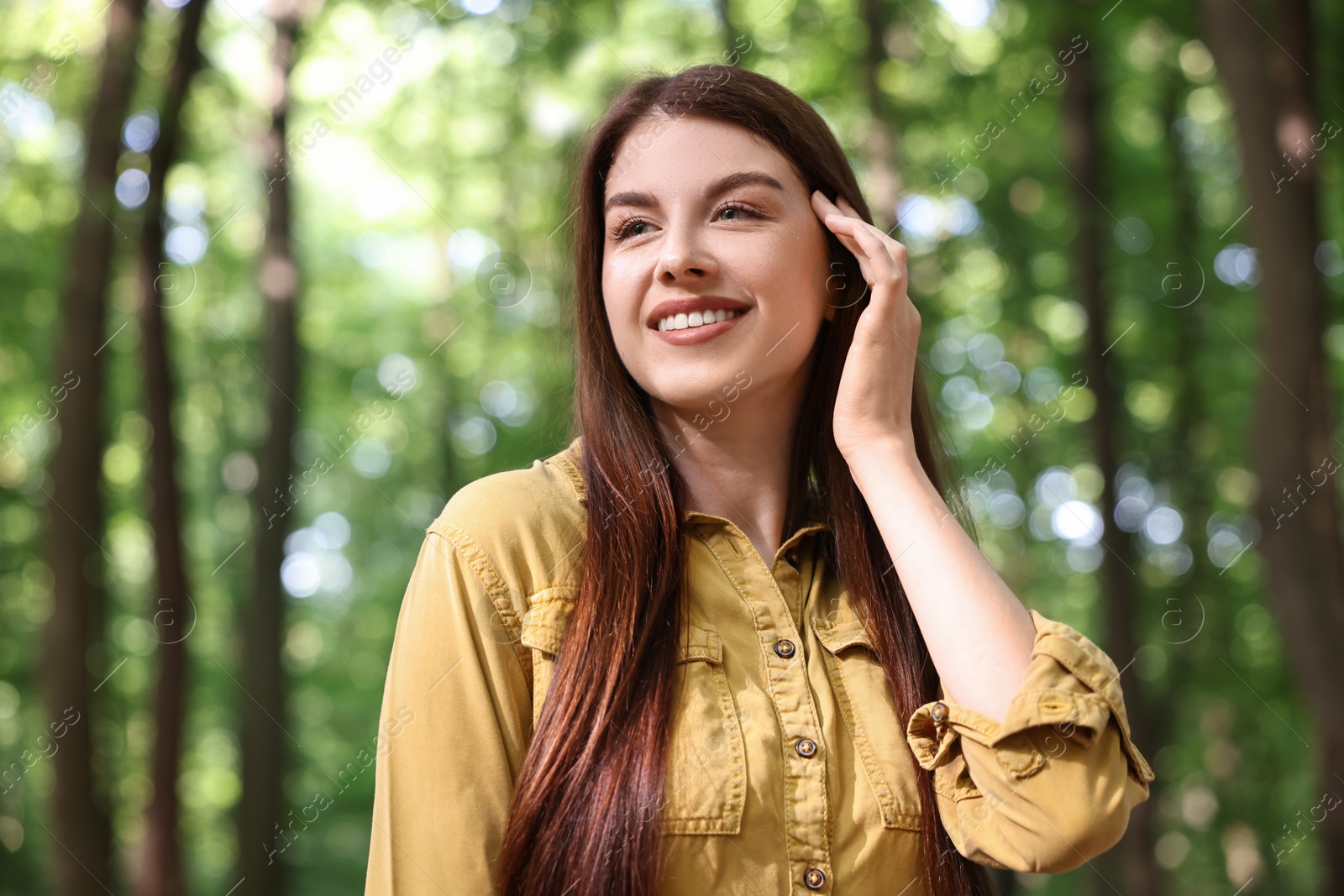 Photo of Portrait of smiling woman in forest. Spring vibes