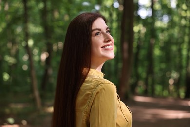 Portrait of smiling woman in forest. Spring vibes