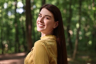 Photo of Portrait of smiling woman in forest. Spring vibes