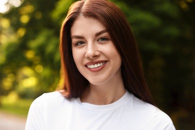 Portrait of smiling woman in park. Spring vibes