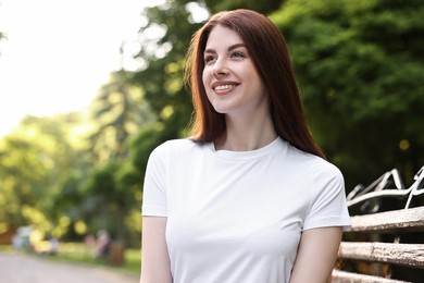 Portrait of smiling woman in park. Spring vibes