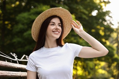 Portrait of smiling woman in hat outdoors. Spring vibes