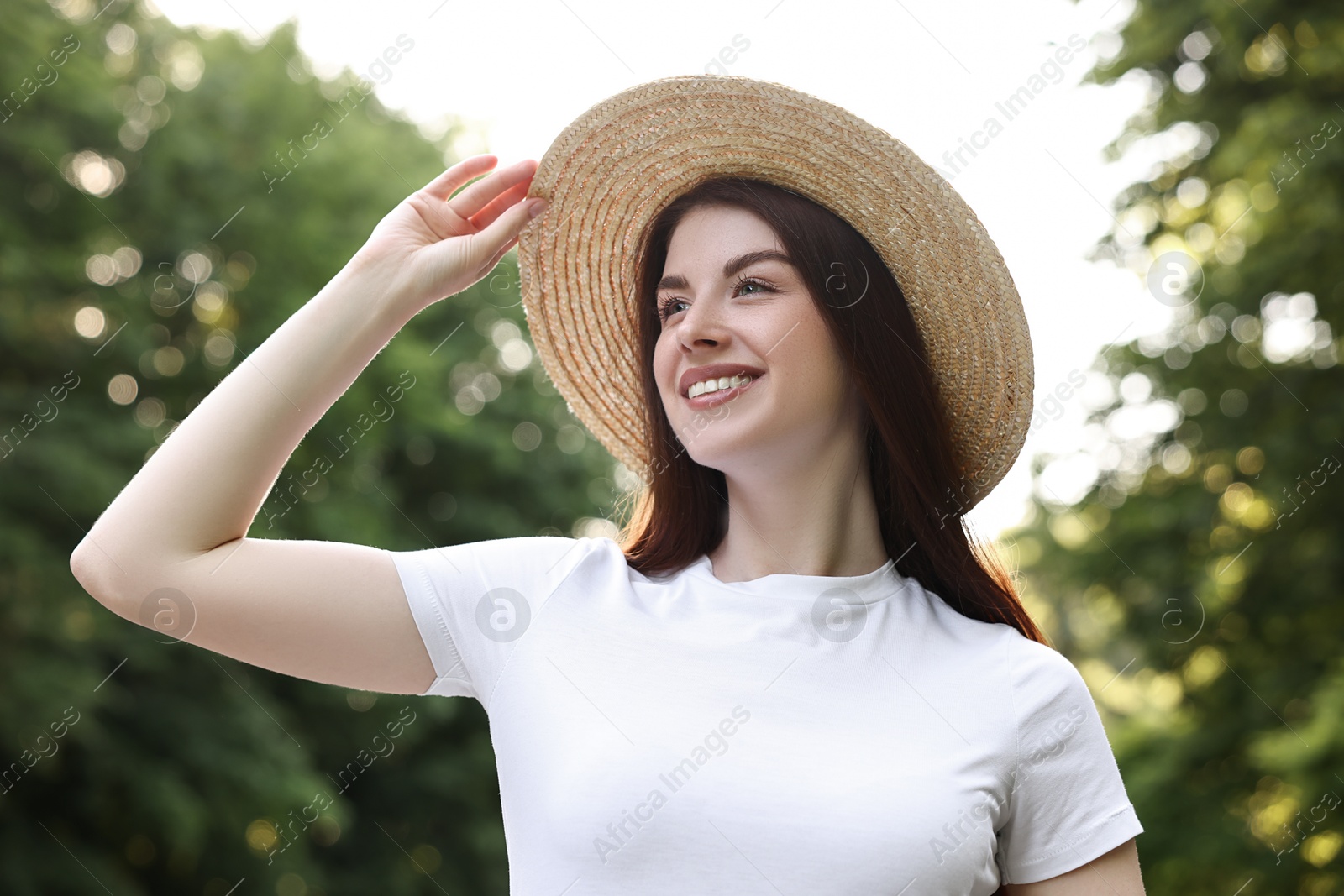 Photo of Portrait of smiling woman in hat outdoors. Spring vibes