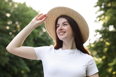 Portrait of smiling woman in hat outdoors. Spring vibes