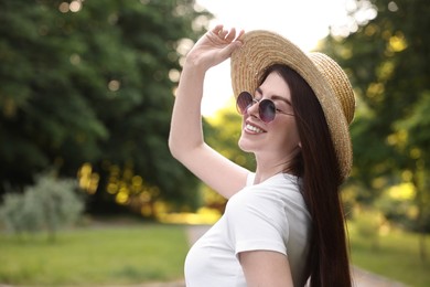Photo of Portrait of smiling woman in hat outdoors, space for text. Spring vibes