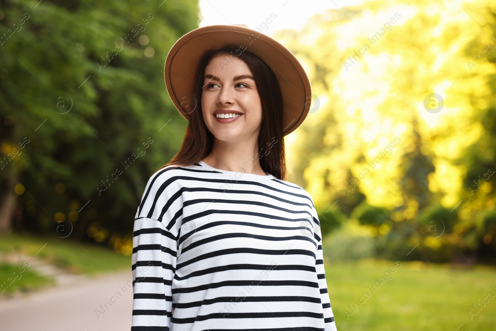 Photo of Portrait of smiling woman in hat outdoors. Spring vibes