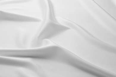Photo of Texture of crumpled white silk fabric as background, closeup