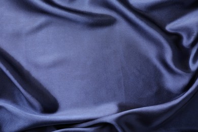 Crumpled dark blue silk fabric as background, top view