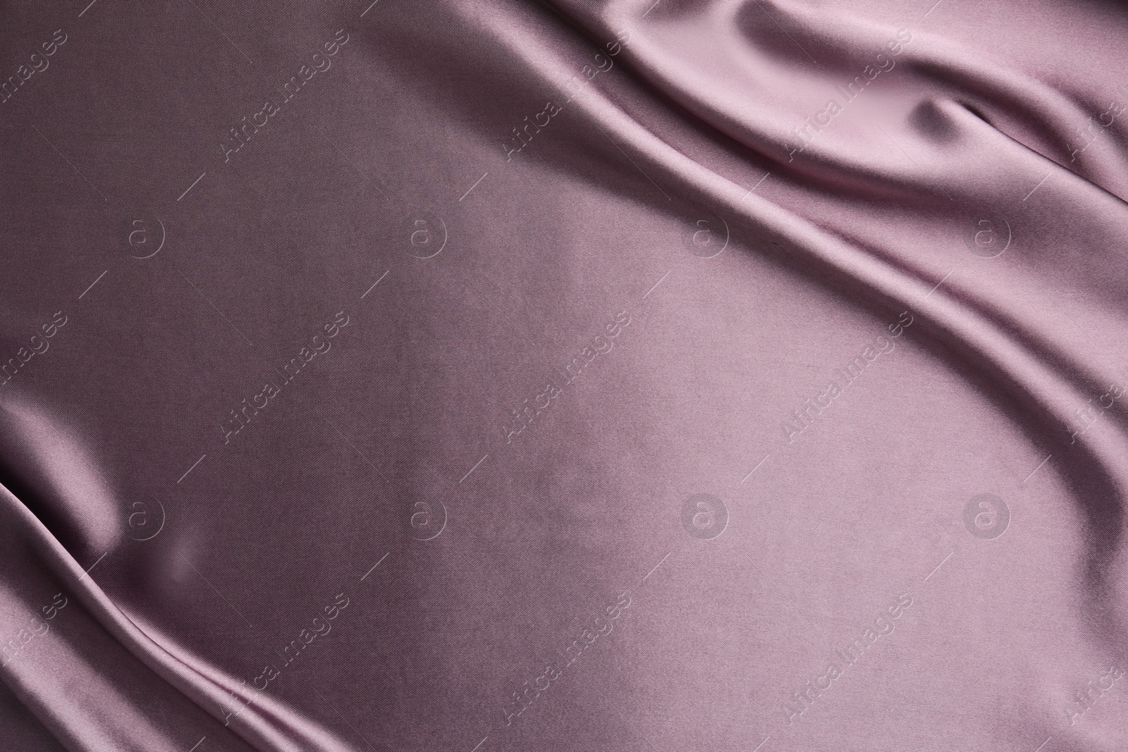 Photo of Crumpled dark purple silk fabric as background, top view. Space for text