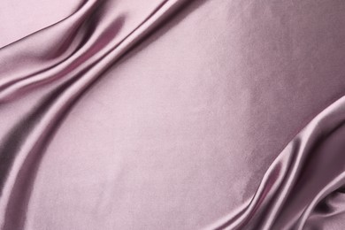 Crumpled dark purple silk fabric as background, top view. Space for text