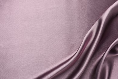 Photo of Crumpled dark purple silk fabric as background, top view. Space for text