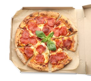 Photo of Tasty pepperoni pizza with basil in cardboard box isolated on white, top view