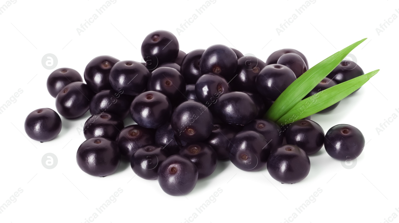 Photo of Fresh ripe acai berries and green leaves isolated on white