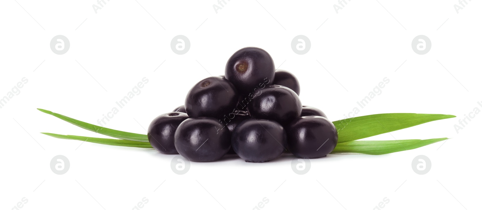 Photo of Fresh ripe acai berries and green leaves isolated on white