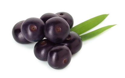 Photo of Fresh ripe acai berries and green leaves isolated on white