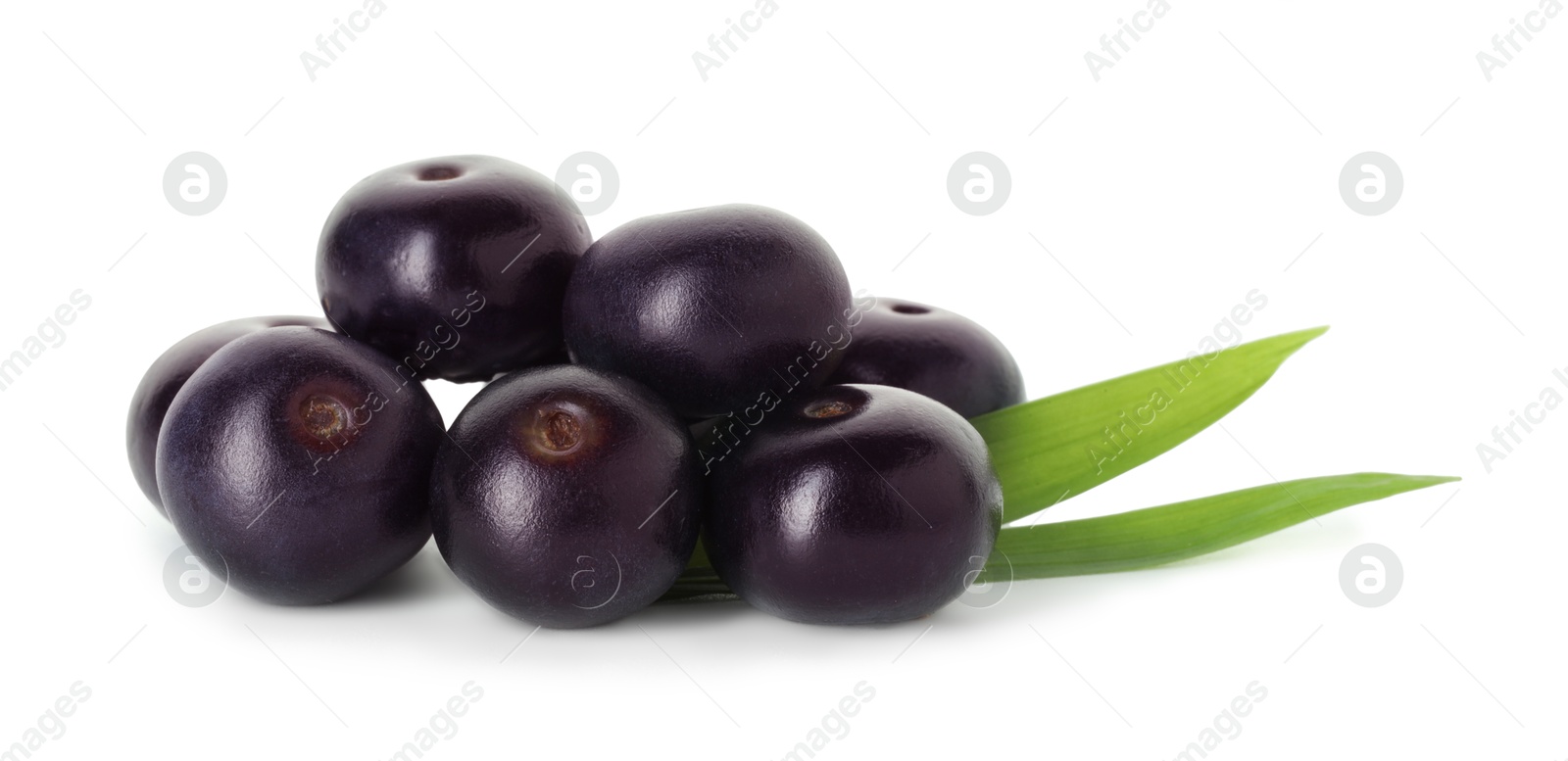 Photo of Fresh ripe acai berries and green leaves isolated on white