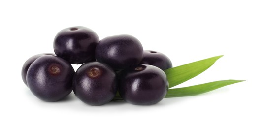 Fresh ripe acai berries and green leaves isolated on white