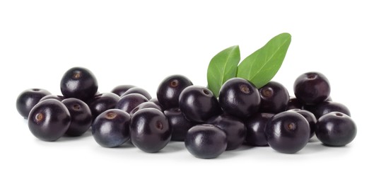 Photo of Fresh ripe acai berries and green leaves isolated on white