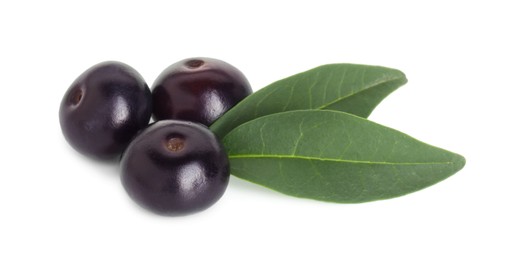 Photo of Fresh ripe acai berries and green leaves isolated on white