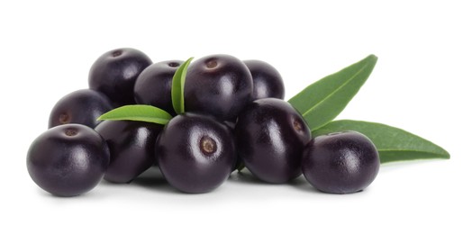 Fresh ripe acai berries and green leaves isolated on white