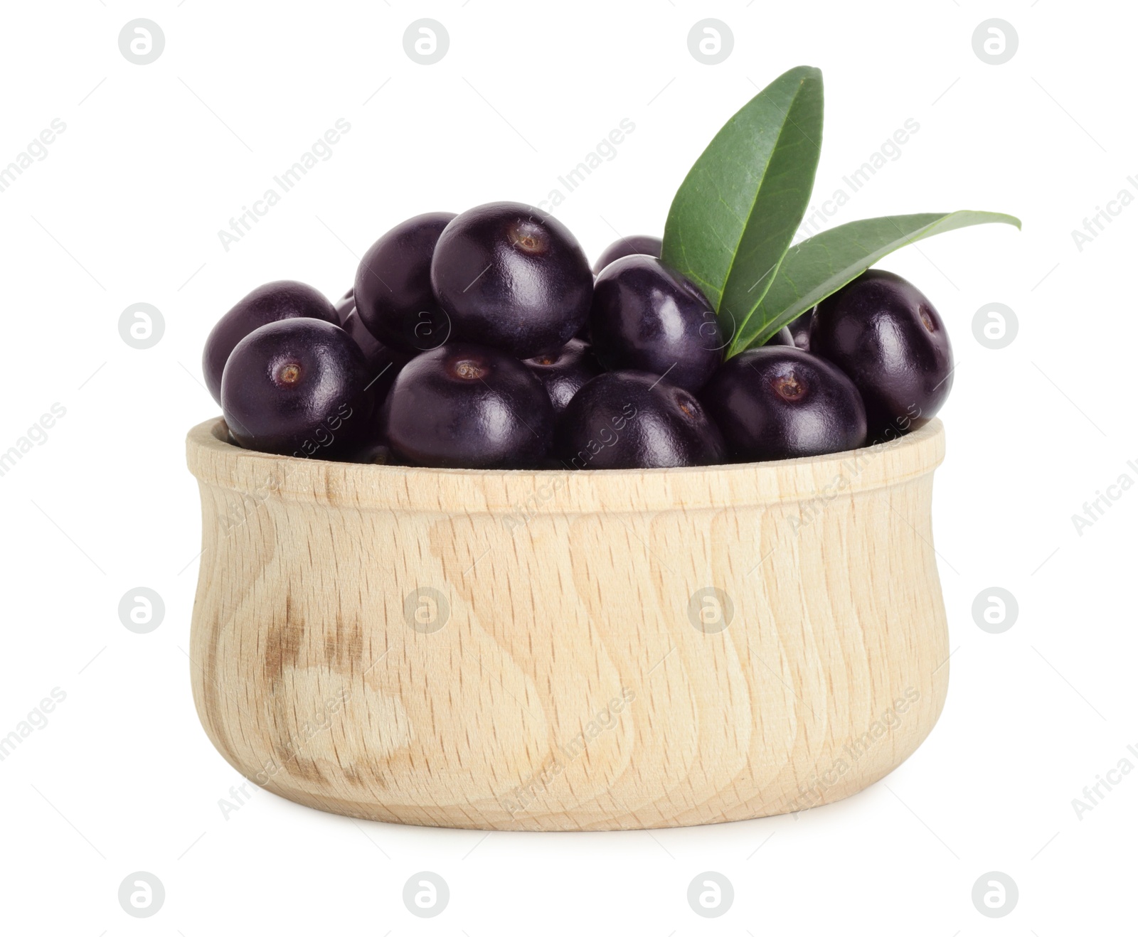 Photo of Fresh ripe acai berries in bowl and green leaves isolated on white