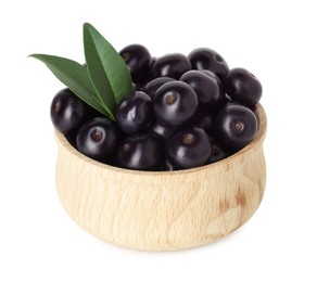 Fresh ripe acai berries in bowl and green leaves isolated on white