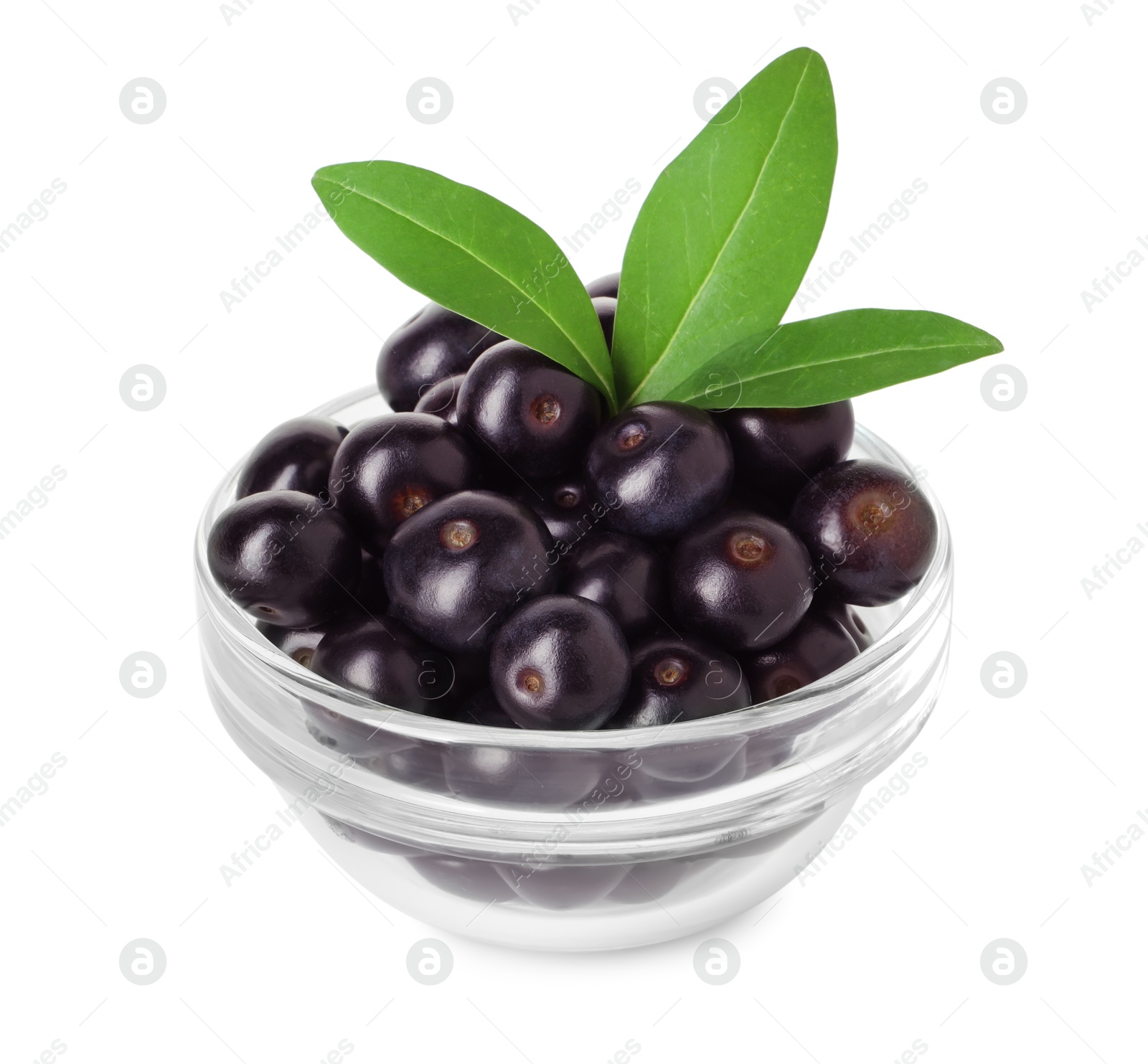 Photo of Fresh ripe acai berries in glass bowl and green leaves isolated on white