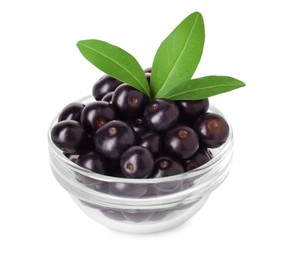 Photo of Fresh ripe acai berries in glass bowl and green leaves isolated on white