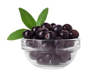 Photo of Fresh ripe acai berries in glass bowl and green leaves isolated on white